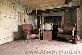 Old comfy chairs and TV left in living room