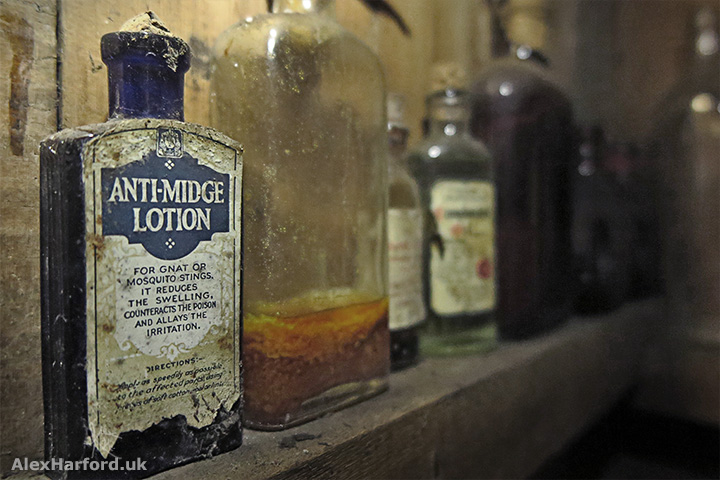 Old anti-midge lotion on a shelf full of bottles