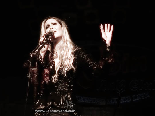Olivia Sparnenn singing (black and white photo)